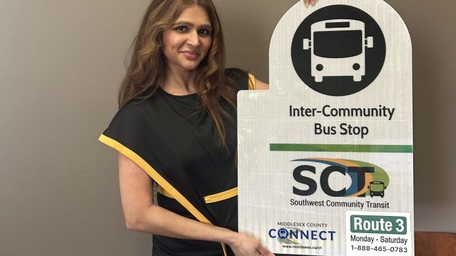 Anum Maqsood with inter community transit sign showing route 3