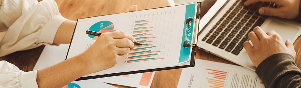 Hands holding charts and doing business